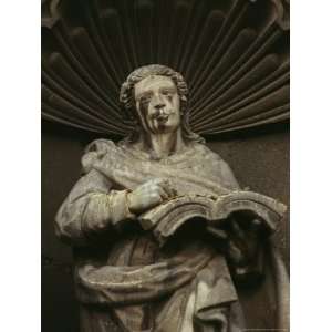  A Statue of a Person Holding an Open Book Architecture 