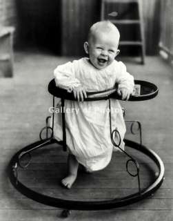   photo The laughing baby in a walker trying to walk 8 x 10  