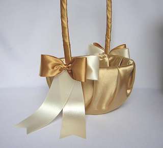 THIS GOLD SATIN GUEST BOOK IS ADORNED WITH 2 IVORY AND GOLD SATIN BOWS 