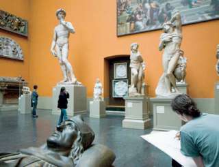 Artist drawing in statue gallery at the Victoria and Albert Museum.